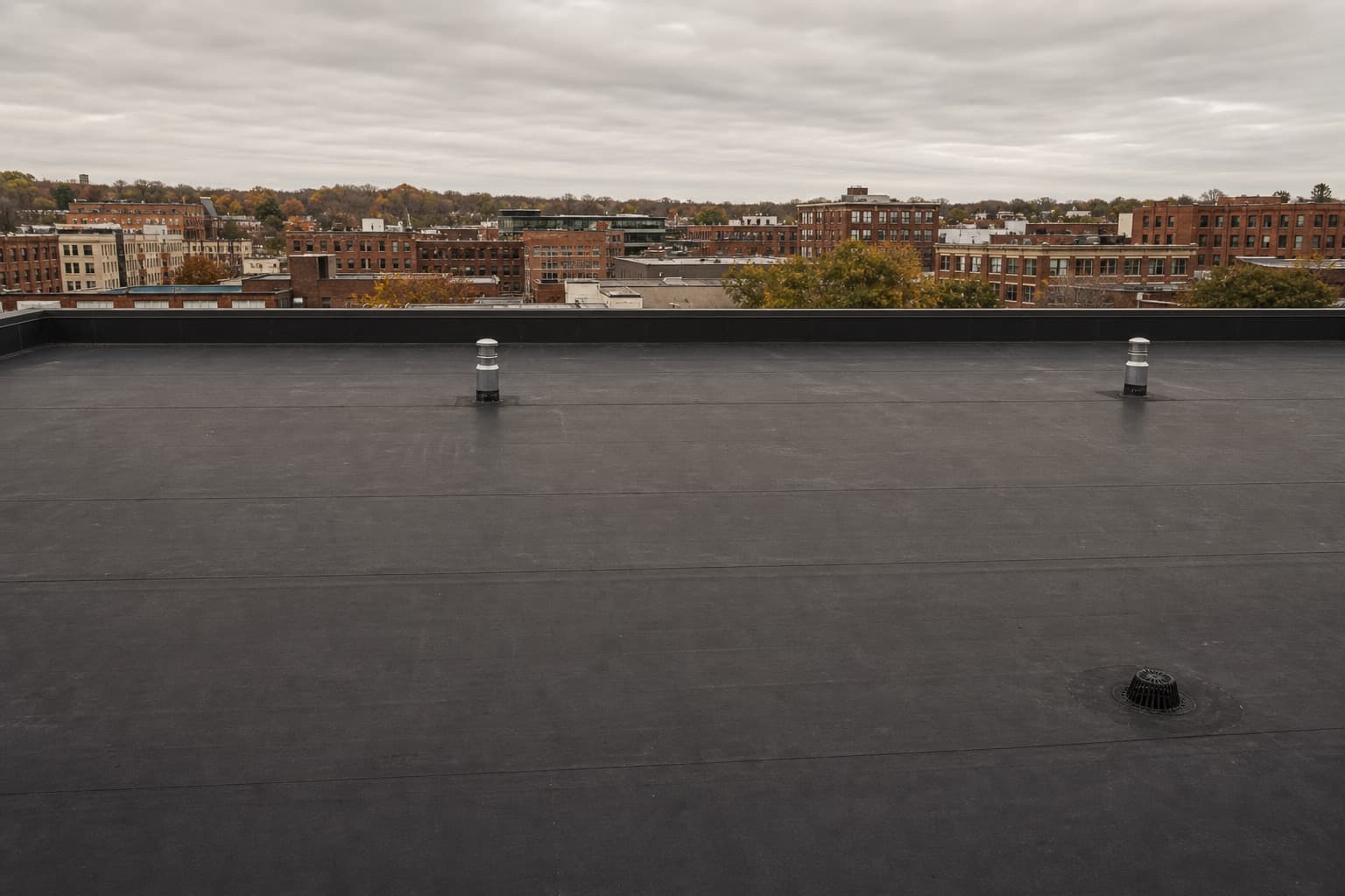 Large black EPDM rubber membrane roof on a commercial building