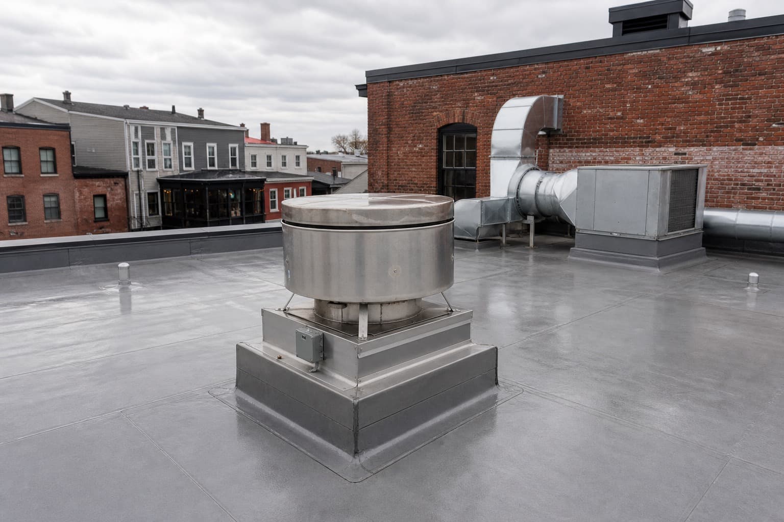 White PVC membrane roof around rooftop kitchen exhaust equipment