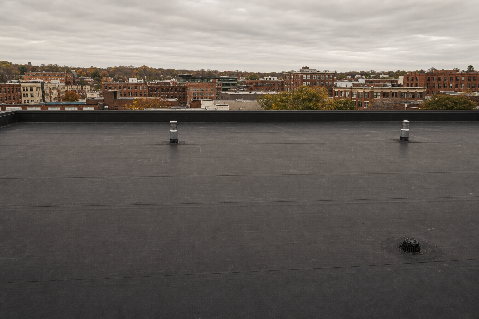 Large black EPDM rubber membrane roof on a commercial building
